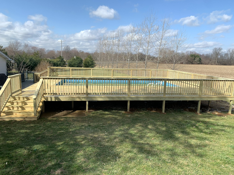 Wood Pool Deck with railing, and stairs.